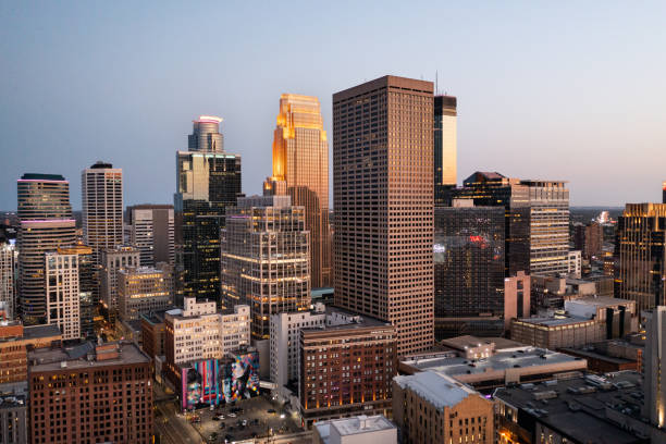 Minneapolis skyline from the Northwest with the setting sun reflecting off the skyscrapers.