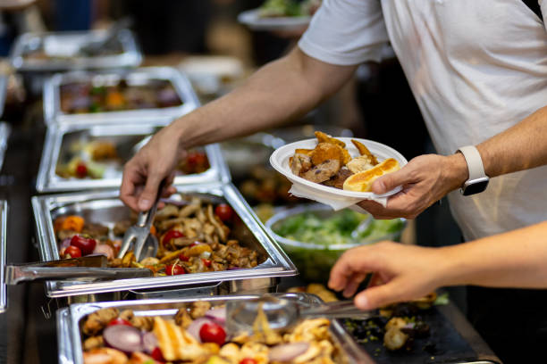 istock A diverse buffet spread with diners selecting food at a casual gathering during lunchtime 2183854671