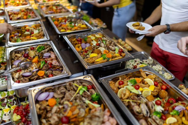 istock A vibrant buffet spread featuring assorted meats, vegetables, and desserts at a lively gathering during an evening event 2183854780