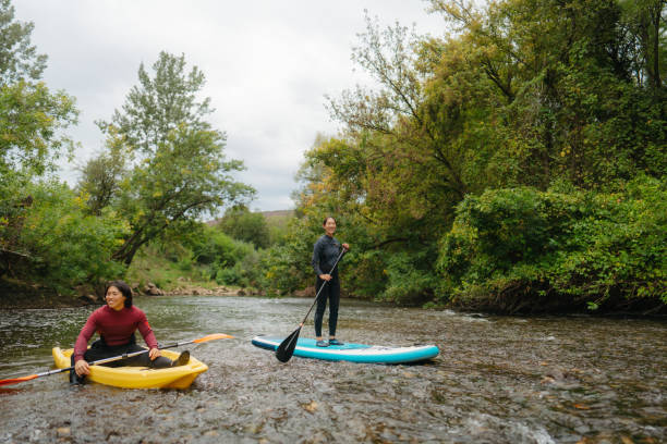 istock Paddleboarding and kayaking together on the river 2183859458