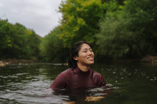 istock Triathlete swimming in the river 2183859476