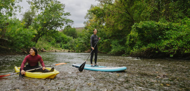 istock Paddleboarding and kayaking together on the river 2183859525