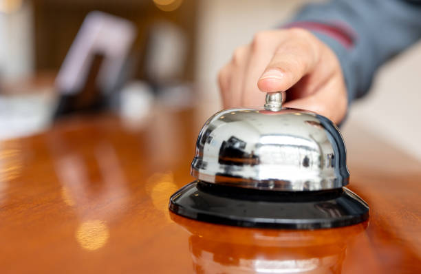 istock Guest ringing the bell at a hotel reception 2183861934
