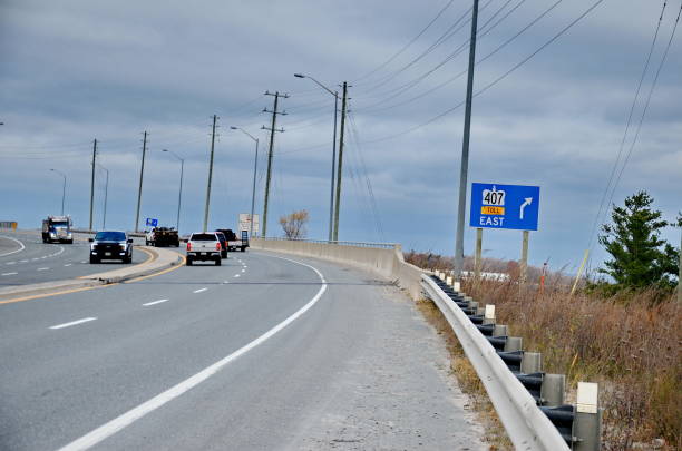 Markham, Ontario, Canada, November 8, 2024: Traffic and road signs on Highway 407 near Markham, Ontario. The 407 ETR is an express toll route highway owned by the 407 International Inc.