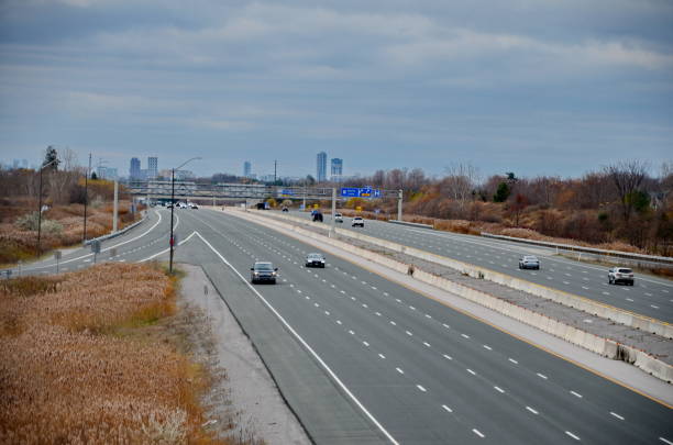 Large highway , traffic heading Toronto, cityscape, CN tower. Cars, traffic, highway lanes. Ontario, Canada.