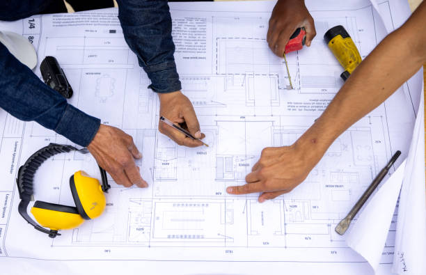 istock Close-up on a group of building contractors looking at a blueprint 2183863085