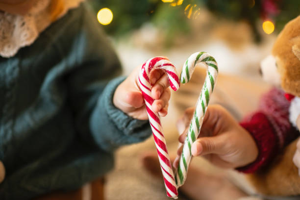 istock Children with candy canes near Christmas tree 2183865544