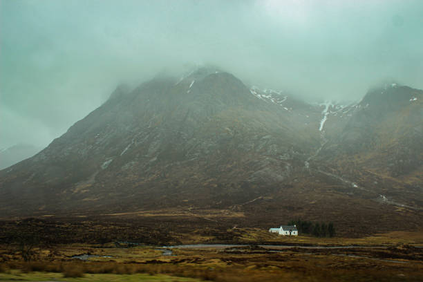 A Solitary Refuge Beneath the Misty Peaks