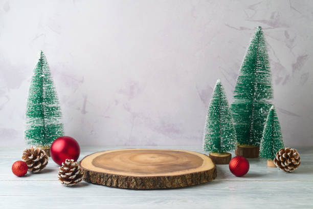 istock Empty log podium and pine tree decoration on white wooden table over bright wall  background. Christmas mock up for design and product display 2183868563