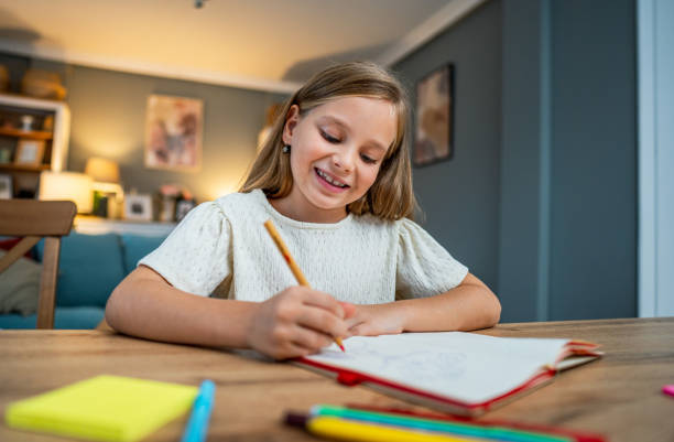 istock Girl doing homework at home 2183868927