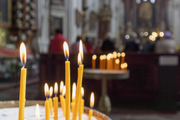 istock .burning a yellow candle in the church 2183868985