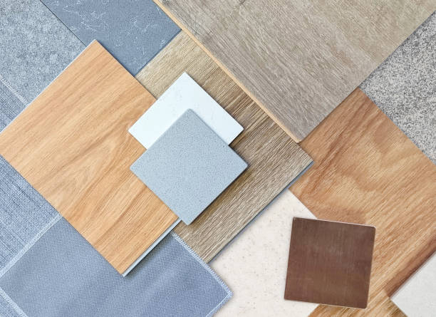 istock top view of interior material samples contains wooden laminate flooring tile, artificial stone, wooden vinyl flooring tile, quartz stone, grey fabric, gold brushed stainless, stone tile in top view. 2183871757