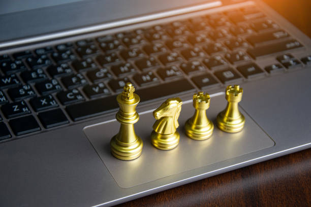 istock Golden chess king placed on laptop, corporate leadership concept 2183872763