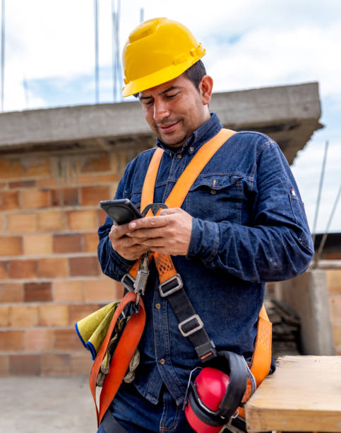 istock Building contractor texting on his cell phone at a construction site 2183878784