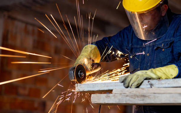 istock Construction worker using an electric saw to cut a piece of metal 2183878790