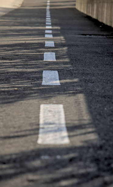 istock white traffic lines on asphalt 2183880186