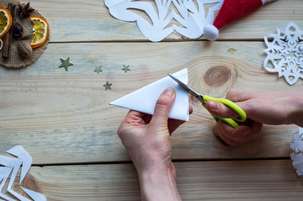 istock A snowflake made from paper with your own hands gracefully decorates a winter interior, adding warmth and a cozy atmosphere 2183882316