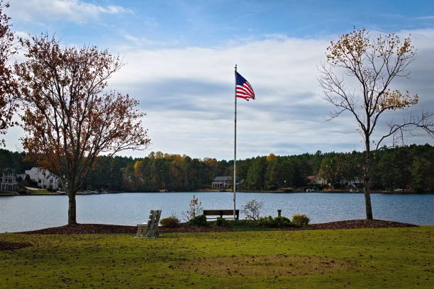 istock Unites States Flag Blowing Next to Lake 2183884532