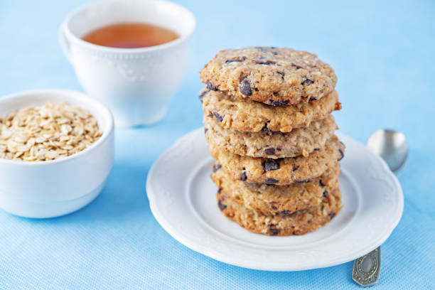 Oatmeal cookies with chocolate drops on a blue background. toning