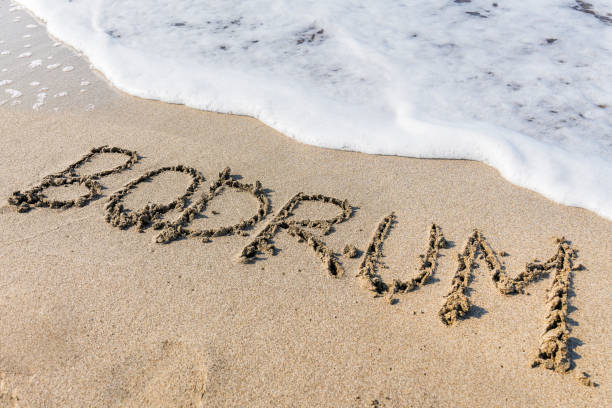 istock Bodrum written on the sand of the beach 2183887000