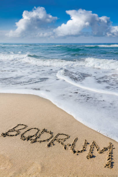 istock Bodrum written on the sand of the beach 2183887009