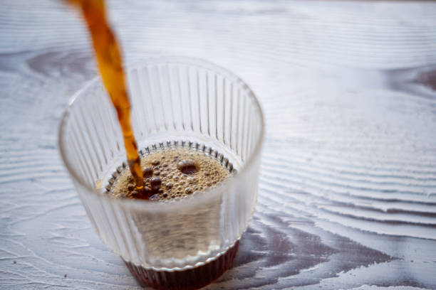 istock pouring filter coffee into glass cup 2183889539