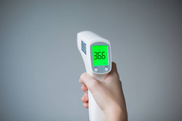 istock Digital Thermometer in Hands Showing 36.6 Temperature 2183895323