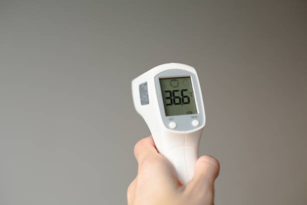 istock Digital Thermometer in Hands Showing 36.6 Temperature 2183895325
