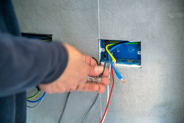 New House Electrical Works with Electrician Working on Installation and Wiring.