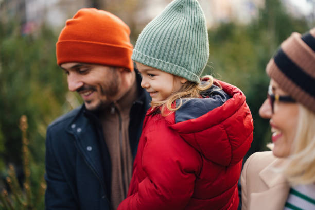 istock Joyful Family Selecting Christmas Tree for Holiday Celebration 2183898409