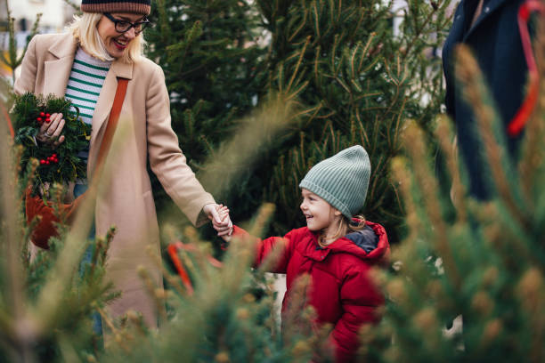 istock Joyful Family Selecting Christmas Tree During Winter Festivities 2183898418