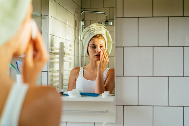 istock Young woman applying hydration creme in the bathroom 2183898614