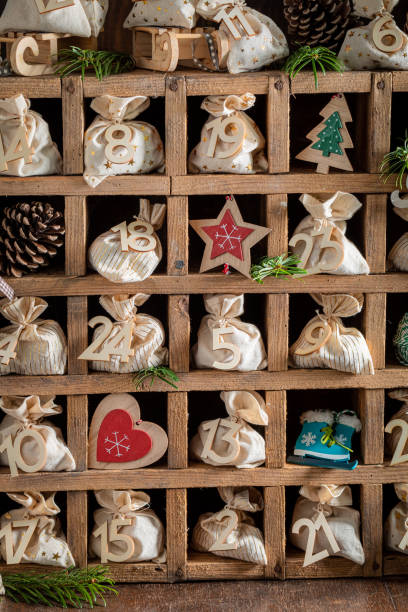 Christmas Advent calendar in the shape of a house with boxes making up the number 2025 in the foreground. High quality photo.