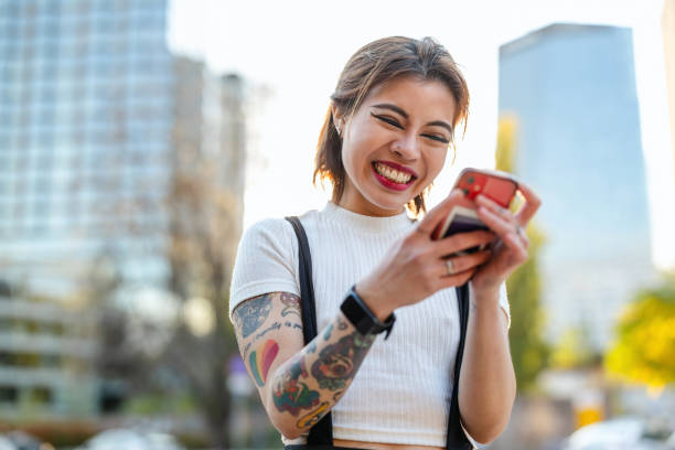 istock Happy young woman using mobile phone in the city 2183908594