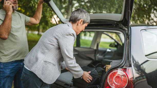 istock Elderly couple loading car trunk with items before a journey together 2183908888
