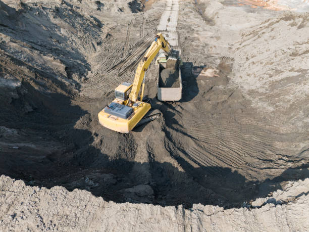 istock Excavators and dump trucks cooperate with each other to transport sand and soil 2183909184