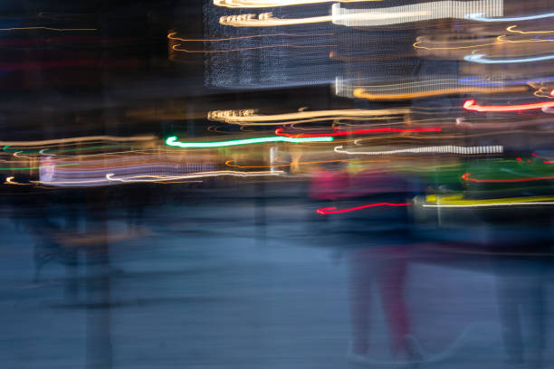 ICM photo of the Edinburgh city centre at dusk in blurred motion, unrecognisable people and trail lights