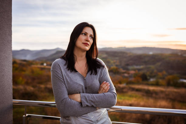 istock Serene Woman Reflecting Outdoors at Sunset in Tranquil Landscape 2183911153