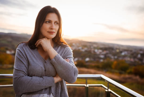 istock Serene Woman Reflecting Outdoors at Sunset in Tranquil Landscape 2183911160