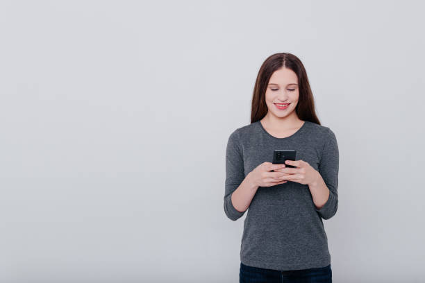 istock young woman with smartphone 2183915398