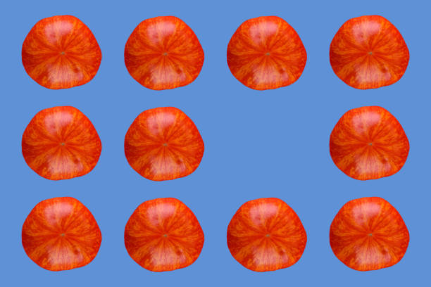 A grid-like pattern of fresh, juicy tomato on blue background.