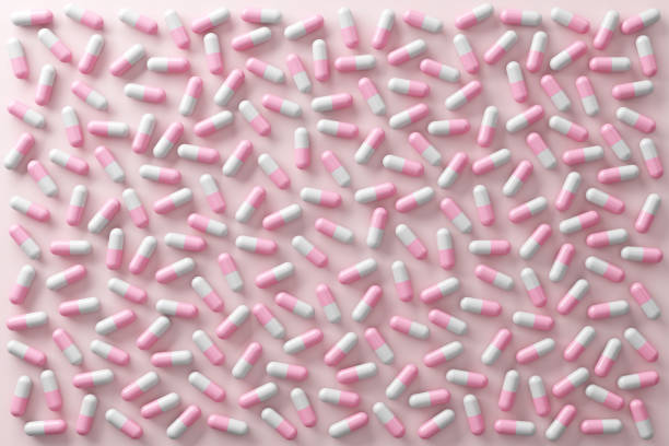 istock Cute pink pastel medicine capsules pill on light pink background. Top view advertisement about hospitals pharmacies and vitamin. The pills scattered on the floor. clipping path. 3D Illustration. 2183920672