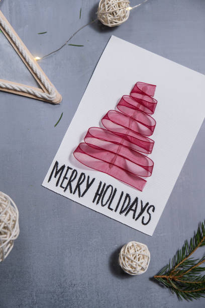 istock Christmas tree ribbon Sustainable Christmas preparation Diy process of making handmade greeting cards. Step by step activity for children. Inclusive and responsible stress relief holiday hobby 2183929076