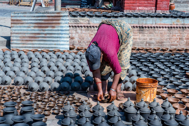 People drying clay pottery in the sunshine during the Tihar festival in Bhaktapur, Nepal, on October 22, 2024.