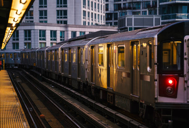 Elevated subway train during sunset in Queens, New York City stock photo