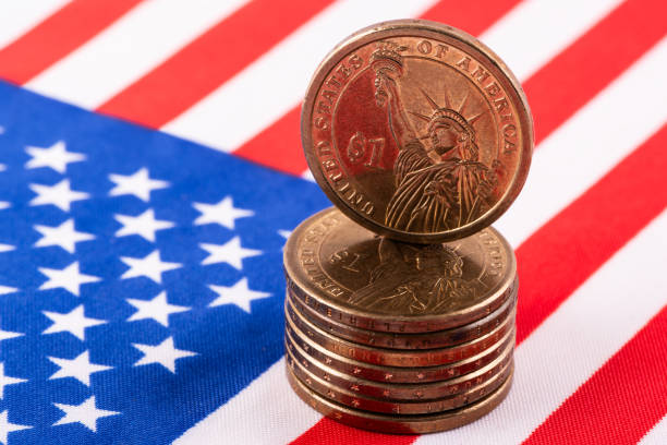 istock 1 US dollar coin and American flag 2183939863
