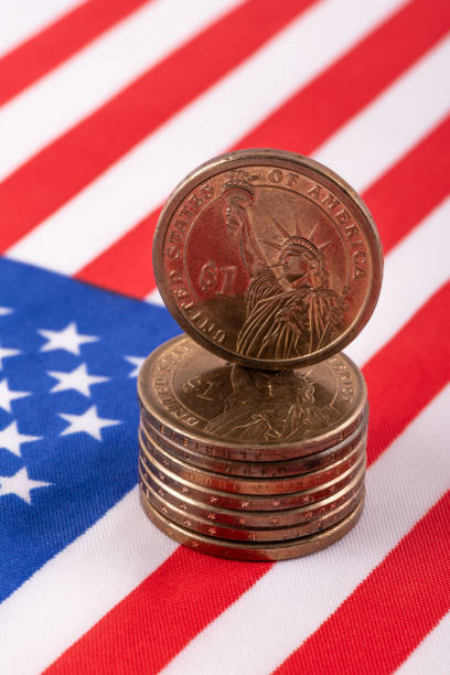 istock 1 US dollar coin and American flag 2183939865
