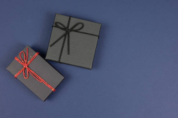 istock Top view with copy space of black gift box on dark blue background. 2183941075