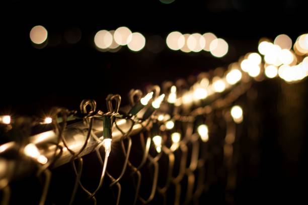 istock Warm Holiday Lights on a Chainlink Fence 2183942140