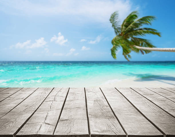 istock Empty wooden table top with beautiful tropical turquoise sea and coconut palm tree background 2183943176